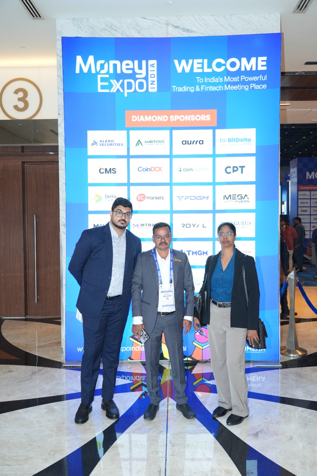 Finnovic team members at the Money Expo India 2026 welcome and sponsor wall
